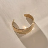 Guardian Hammered Cuff in gold at an angle, showing the open back and textured surface.