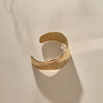 Guardian Hammered Cuff in gold from above, showing the cuff opening.