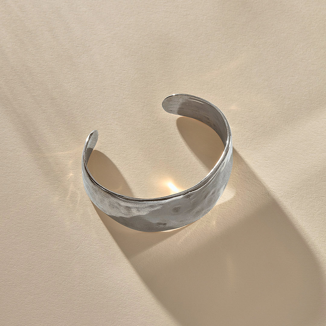 Guardian Hammered Cuff in sterling silver at an angle, showing the open back and textured surface.