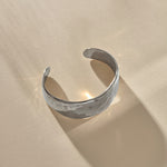 Guardian Hammered Cuff in sterling silver at an angle, showing the open back and textured surface.