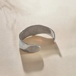 Guardian Hammered Cuff in sterling silver from the side, showing its wide, flowing band.