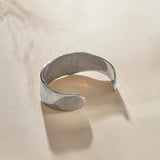 Guardian Hammered Cuff in sterling silver from the side, showing its wide, flowing band.