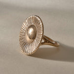 Heart of the Sun Statement Ring in recycled bronze at an angle, a domed center radiating fine carved rays.