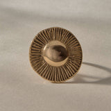 Heart of the Sun Statement Ring in solid recycled gold from the front, a domed center radiating fine carved rays.