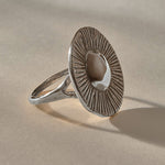 Heart of the Sun Statement Ring in recycled sterling silver from the side, showing the sunburst face and slim band.