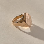 Heritage Textured Signet Ring in recycled bronze at an angle, showing the dappled signet face.
