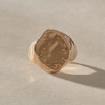 Heritage Textured Signet Ring in recycled bronze from the front, a softly indented, dappled oval face.