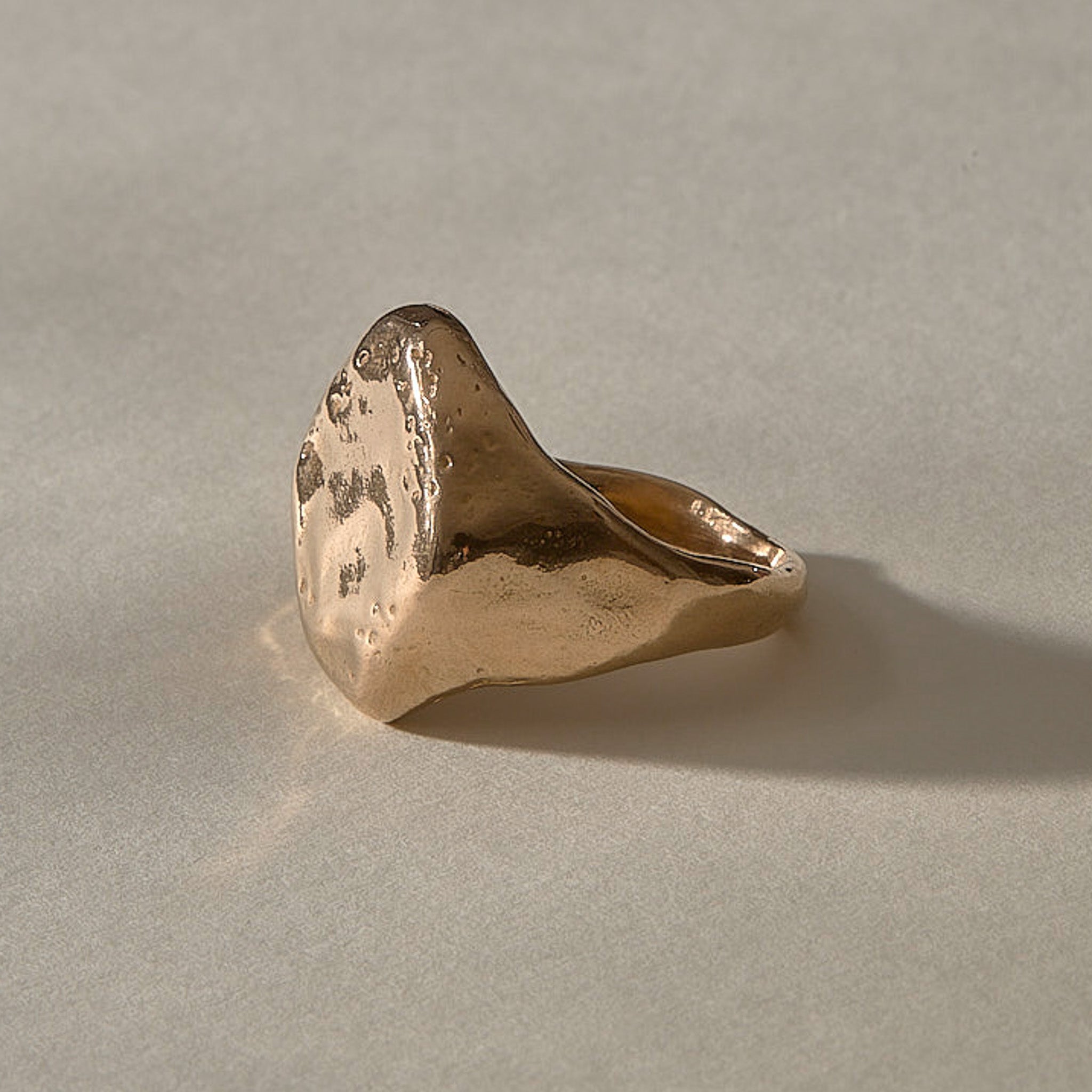 Heritage Textured Signet Ring in recycled bronze from the side, showing the weathered face and tapering band.