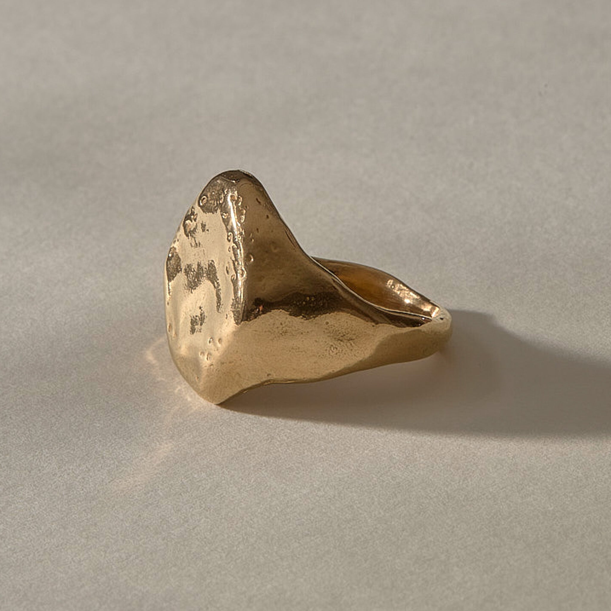 Heritage Textured Signet Ring in solid recycled gold from the side, showing the weathered face and tapering band.