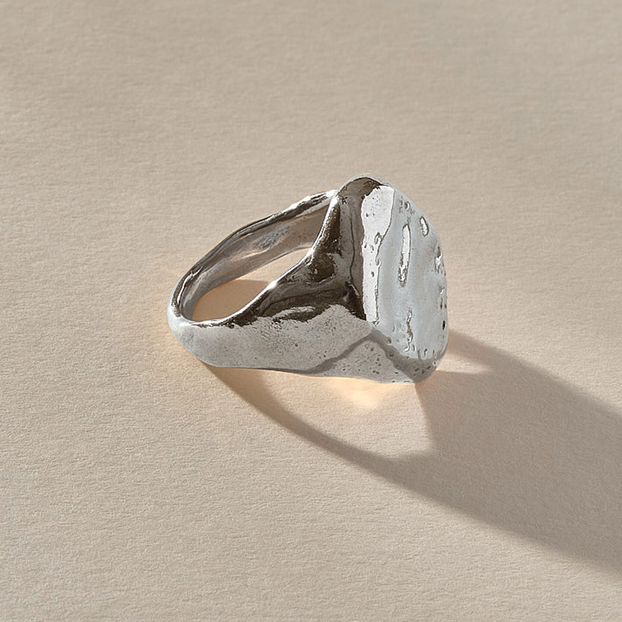 Heritage Textured Signet Ring in recycled sterling silver at an angle, showing the dappled signet face.