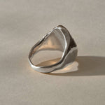 Heritage Textured Signet Ring in recycled sterling silver from the back at an angle, showing the tapering band.