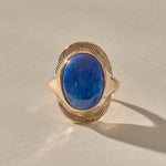 Inanna Lapis Shield Ring in gold from the front, showing the deep blue lapis with golden flecks inside its carved shield.