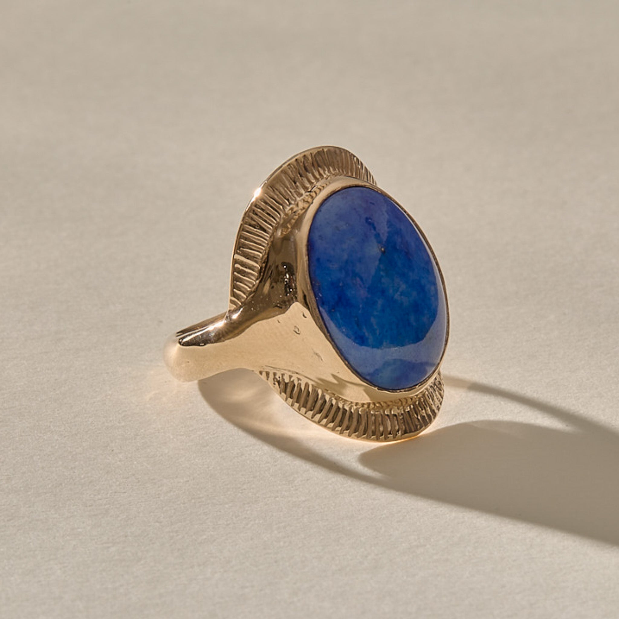 Inanna Lapis Shield Ring in solid gold from the other side, with the lapis catching the light.