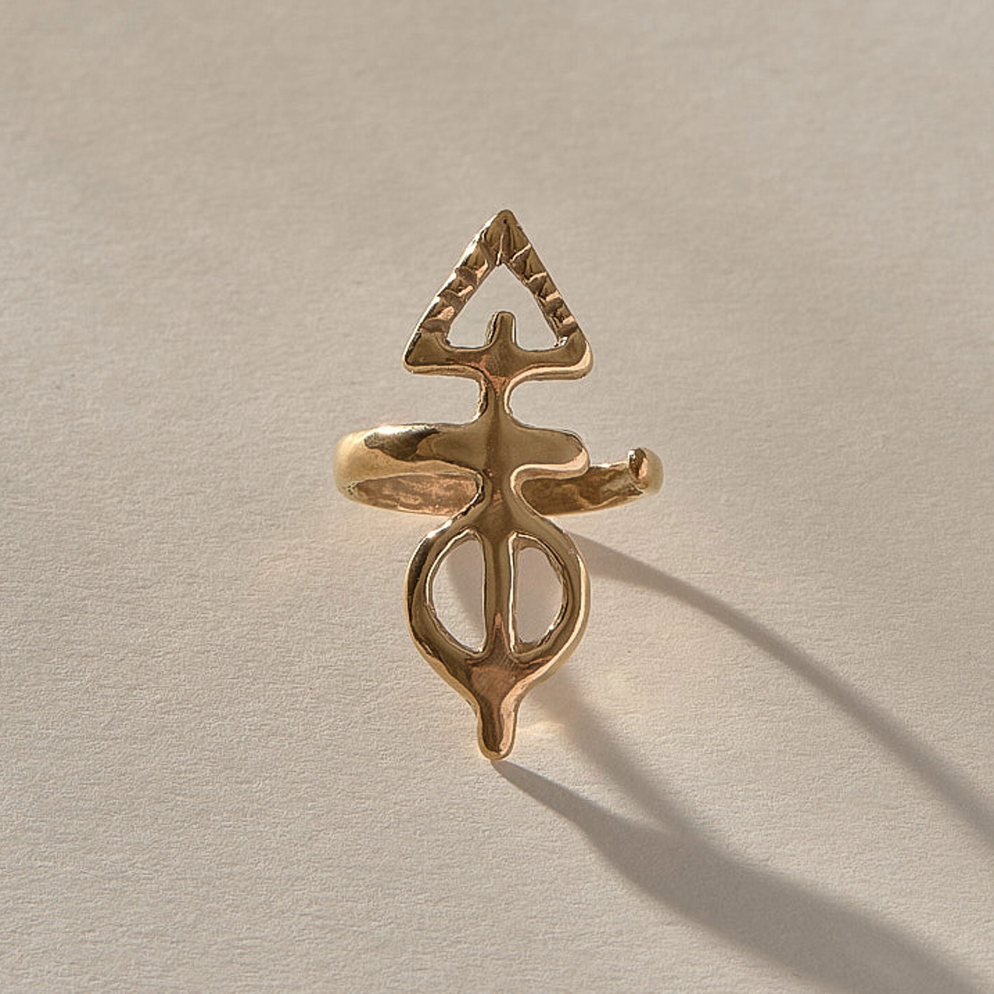 Ma'at Elemental Ring in solid recycled gold, angled view of the sculptural adjustable band