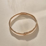 Rustic Magi Bangle in bronze at an angle, showing the spiral markings.