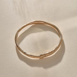 Rustic Magi Bangle in bronze at an angle, showing the spiral markings.