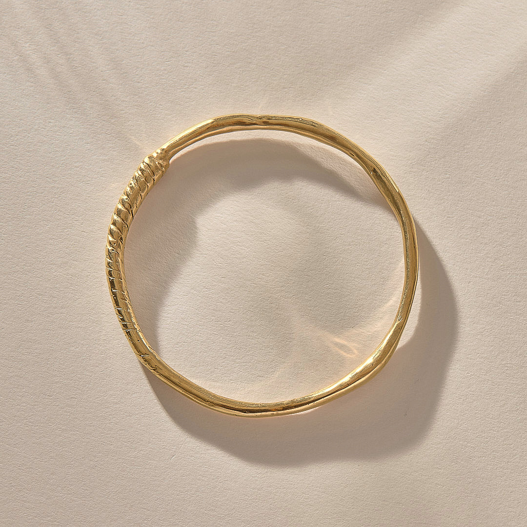 Rustic Magi Bangle in gold from above, showing its organic round shape.