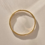 Rustic Magi Bangle in gold from above, showing its organic round shape.
