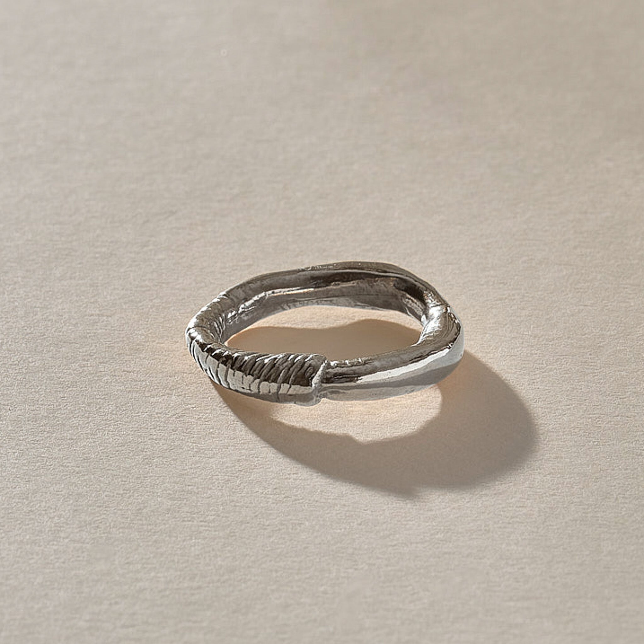 Magi Ring in recycled sterling silver, angled view of the organic textured band