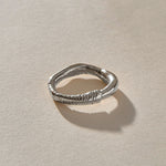 Magi Ring in recycled sterling silver, front view of the uneven hand-carved band