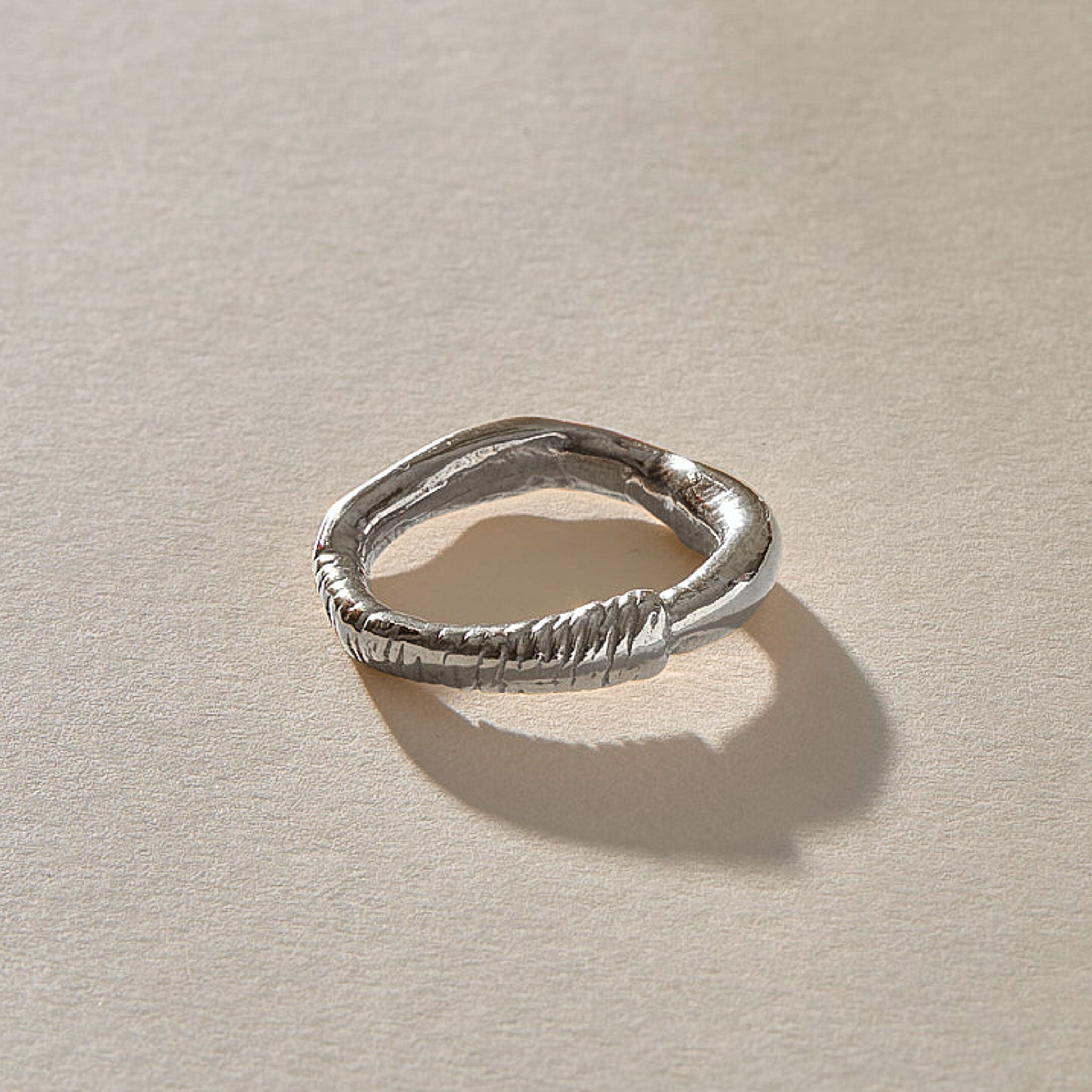 Magi Ring in recycled sterling silver, front view of the uneven hand-carved band