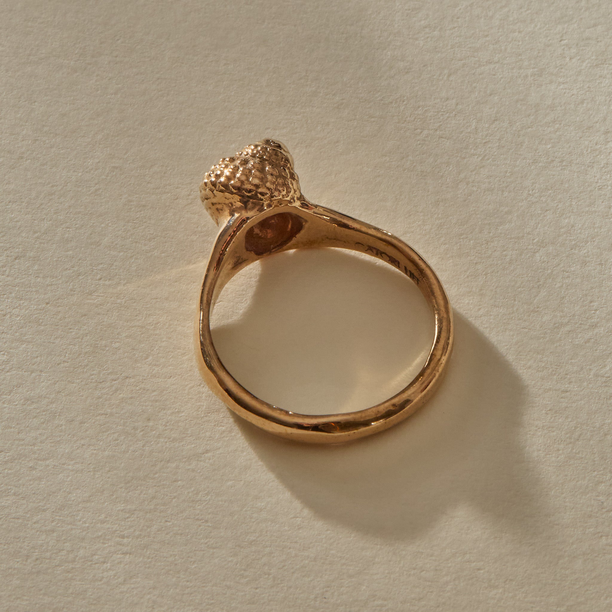 Back view of the Maré Shell Ring in bronze, showing the inside of the band stamped Catori Life.