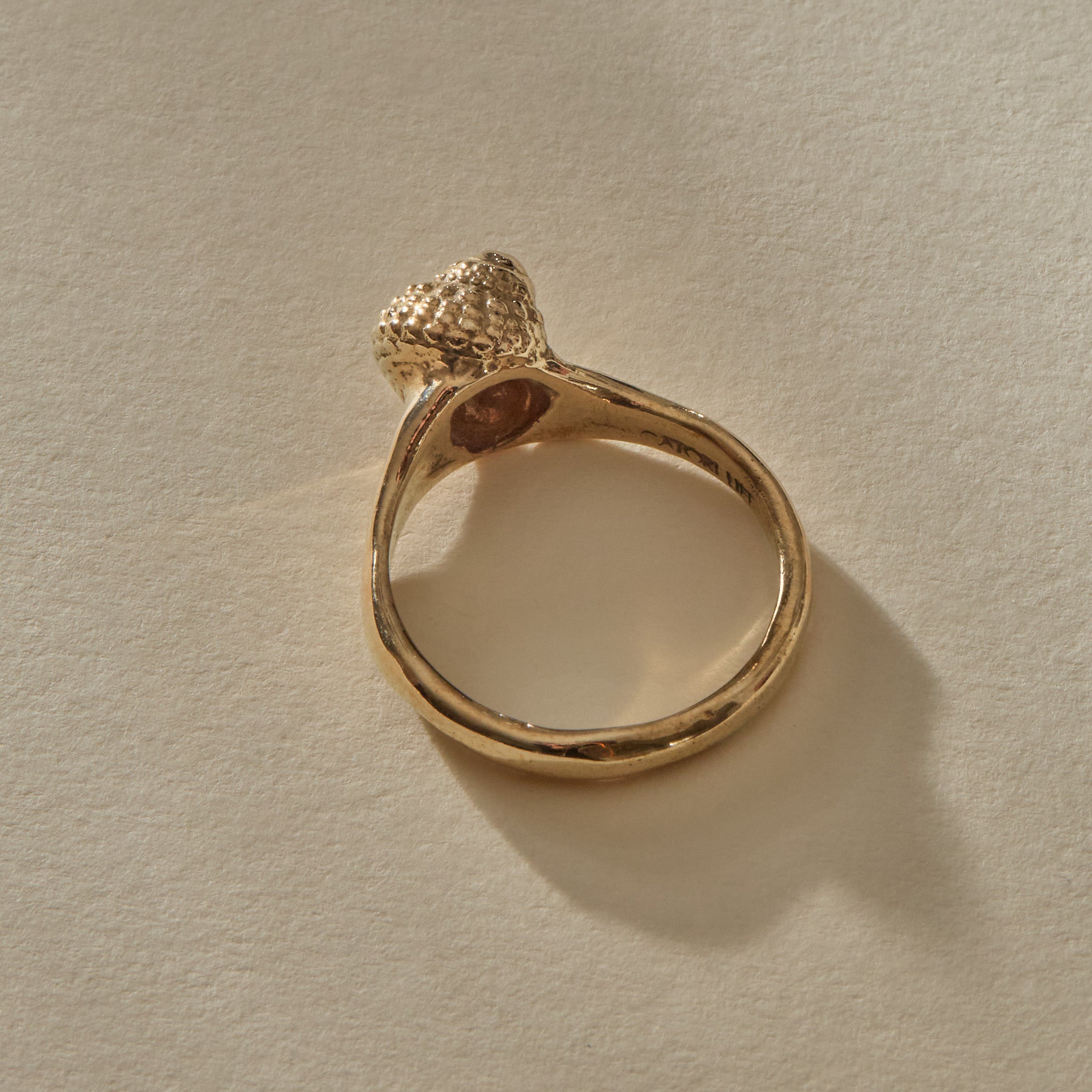 Back view of the Maré Shell Ring in gold, showing the inside of the band stamped Catori Life.