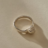 Maré Shell Ring in sterling silver at an angle, showing the textured shell and hand-formed band.
