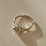 Maré Shell Ring in sterling silver from the front, the shell's spiral opening sitting low on the band.