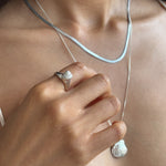 Maré Shell Ring in sterling silver worn on the hand, showing its delicate size.