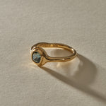 Meridian Ring in 14k gold at an angle, with the hand-formed band flowing into the sapphire bezel.