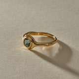 Meridian Ring in 14k gold at an angle, with the hand-formed band flowing into the sapphire bezel.