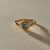 Meridian Montana sapphire ring from the front, showing the cushion cut stone in its rounded gold bezel.