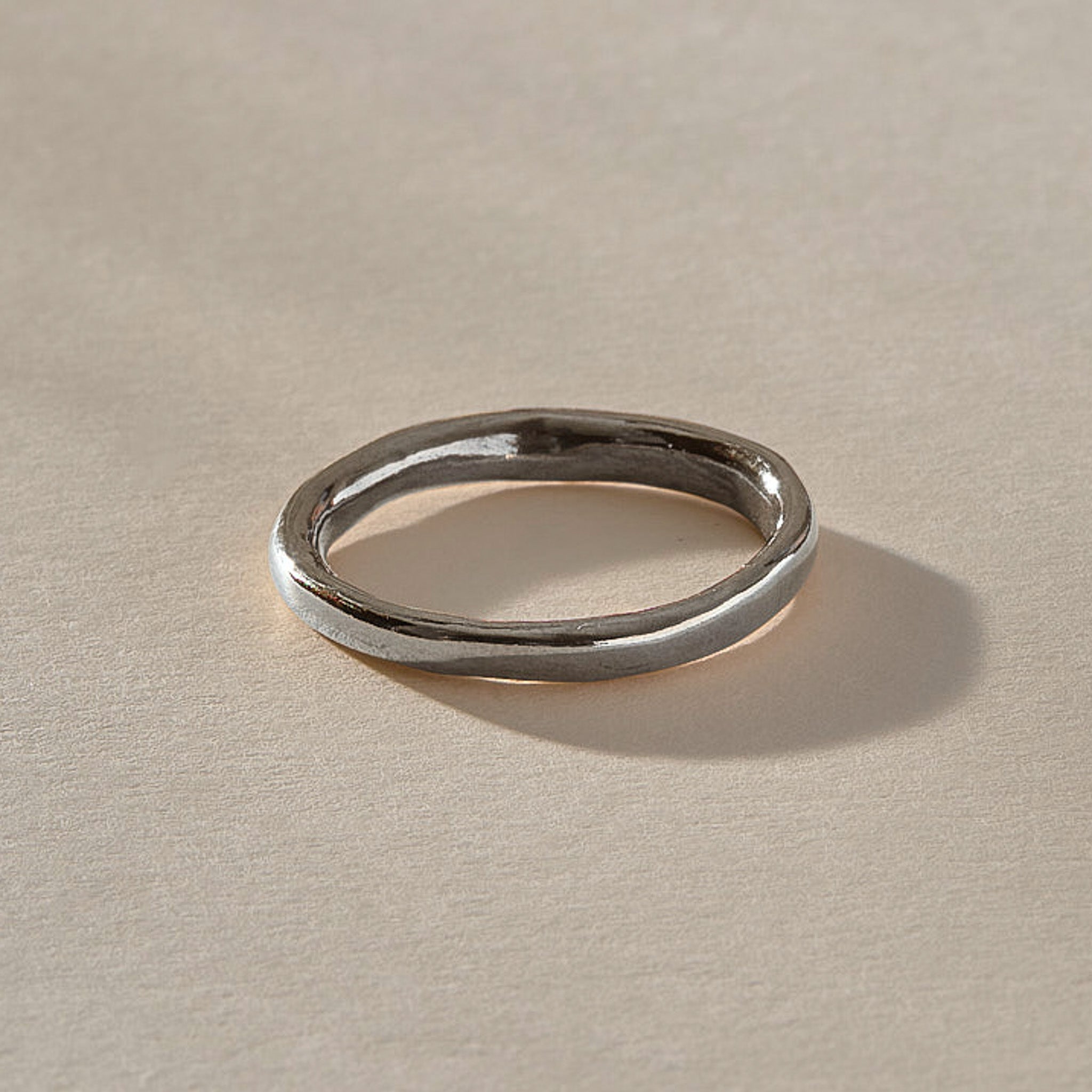Mist Ring in recycled sterling silver, angled view of the softly rising and falling band