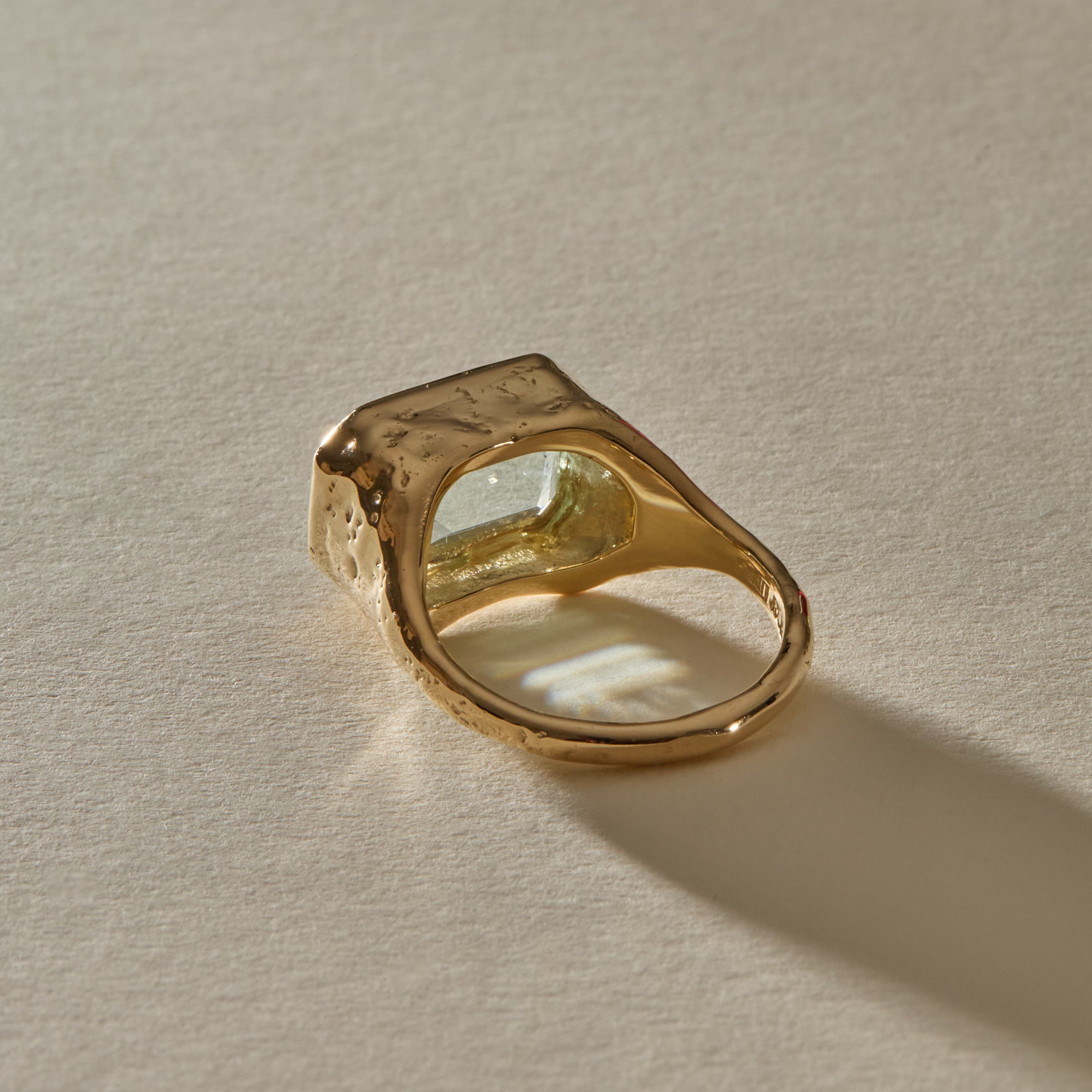 Naïade Ring in 14k gold from behind at an angle, with the organic textured bezel rising around the aquamarine.
