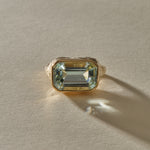 Naïade aquamarine ring from the front, showing the pale, sea-glass clear stone and its stepped facets.
