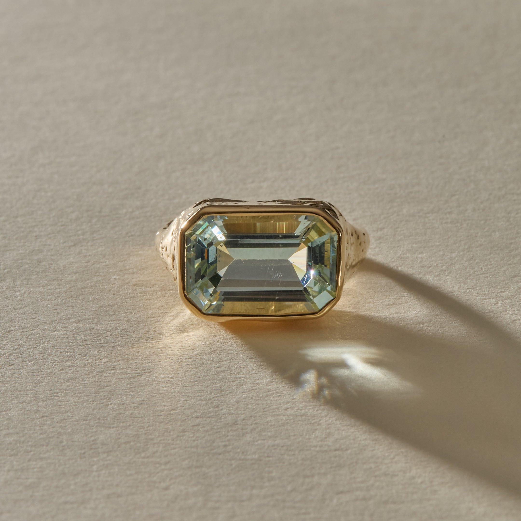 Naïade aquamarine ring from the front, showing the pale, sea-glass clear stone and its stepped facets.