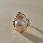 Nereid IV Ring in 14k recycled gold, a large one of a kind baroque pearl with green-gold iridescence held in a molten, organic gold setting.