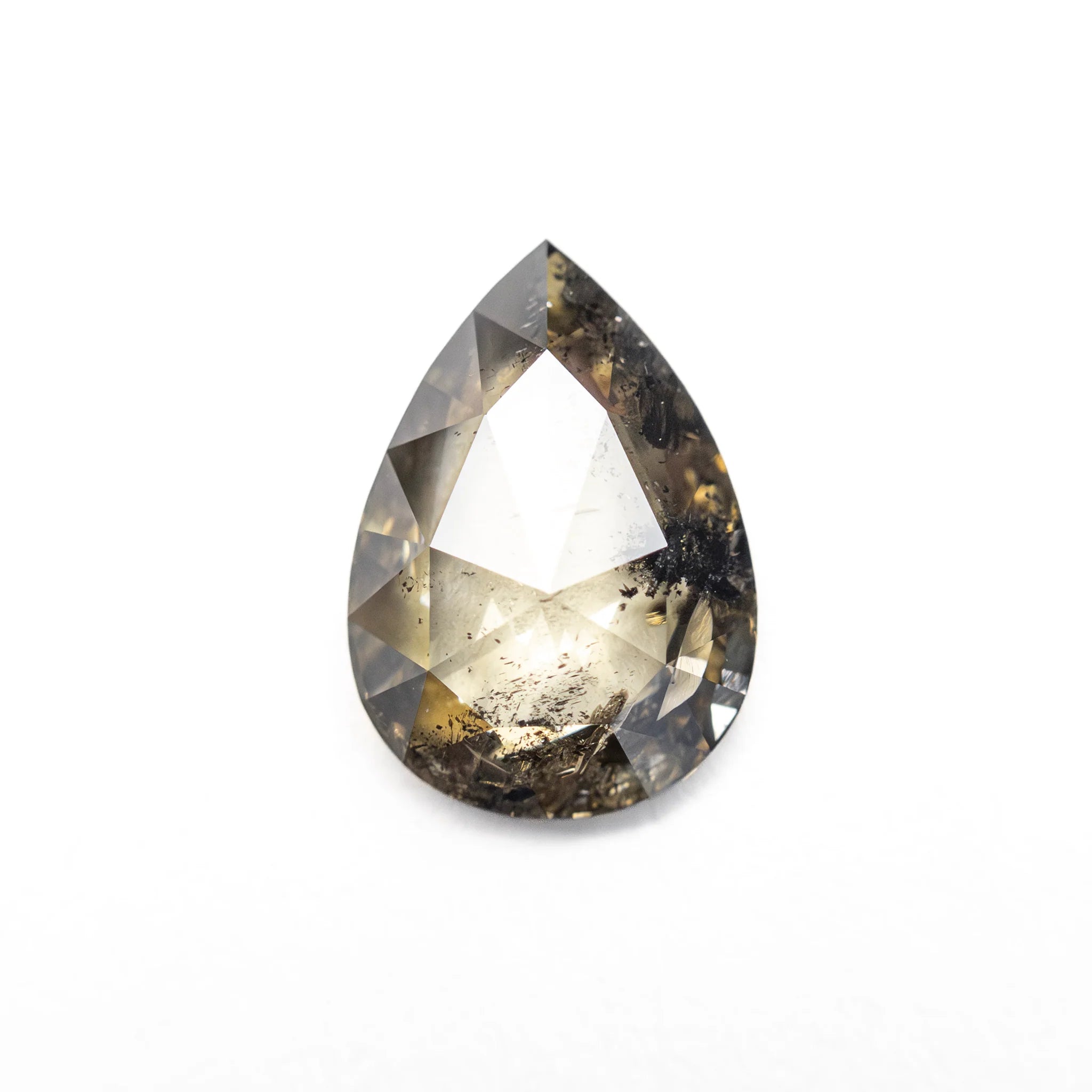 The pear shaped rose cut champagne salt and pepper diamond set in the Oriente Ring, shown loose on a white background.