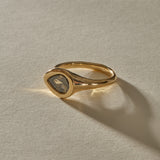 Oriente Ring in 14k gold at an angle, with the band sweeping into the east-west diamond setting.