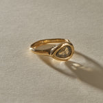 Oriente salt and pepper diamond ring from the front, showing the natural inclusions of the rose cut pear stone.