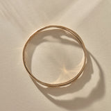Reverie Organic Bangle in bronze from above, showing its flowing, river-like shape.