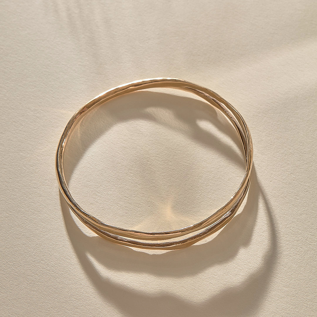 Reverie Organic Bangle Bracelet in recycled bronze, a hand-carved bangle that splits down the center like a canyon.