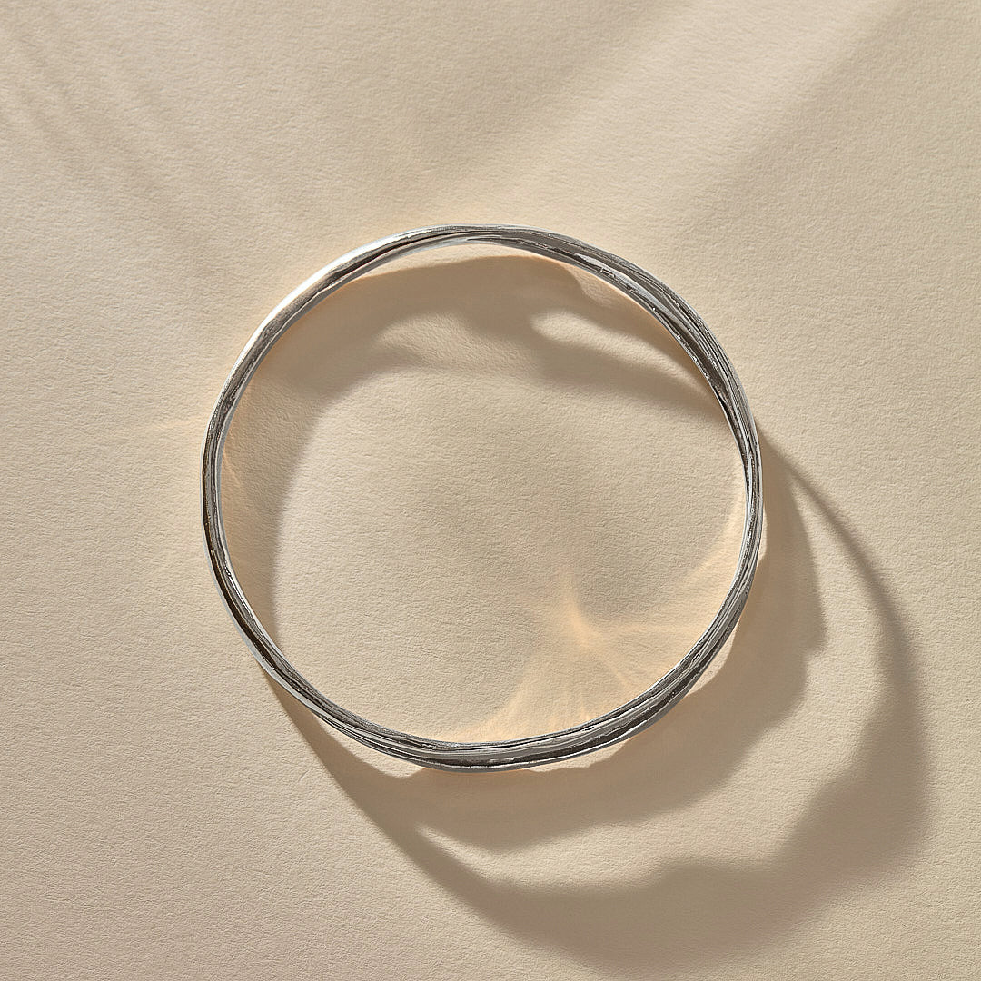 Reverie Organic Bangle in sterling silver from above, showing its flowing, river-like shape.