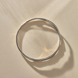 Reverie Organic Bangle in sterling silver from above, showing its flowing, river-like shape.