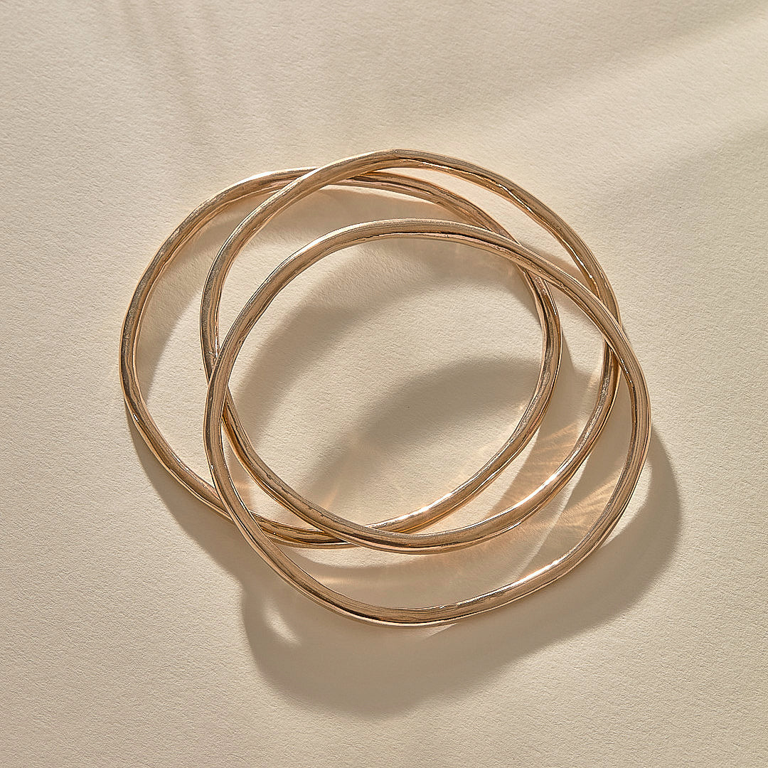 Set of 3 Rustic Bangles in recycled bronze stacked together.