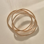 Set of 3 Rustic Bangles in recycled bronze stacked together.