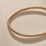 Single Rustic Bangle in bronze from above, showing its organic, slightly uneven shape.