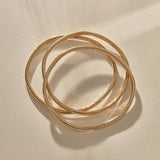 Set of 3 Rustic Bangles in solid recycled gold stacked together.