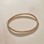 Rustic Bangle Bracelet in solid recycled gold, a single organic hand-polished bangle from above.